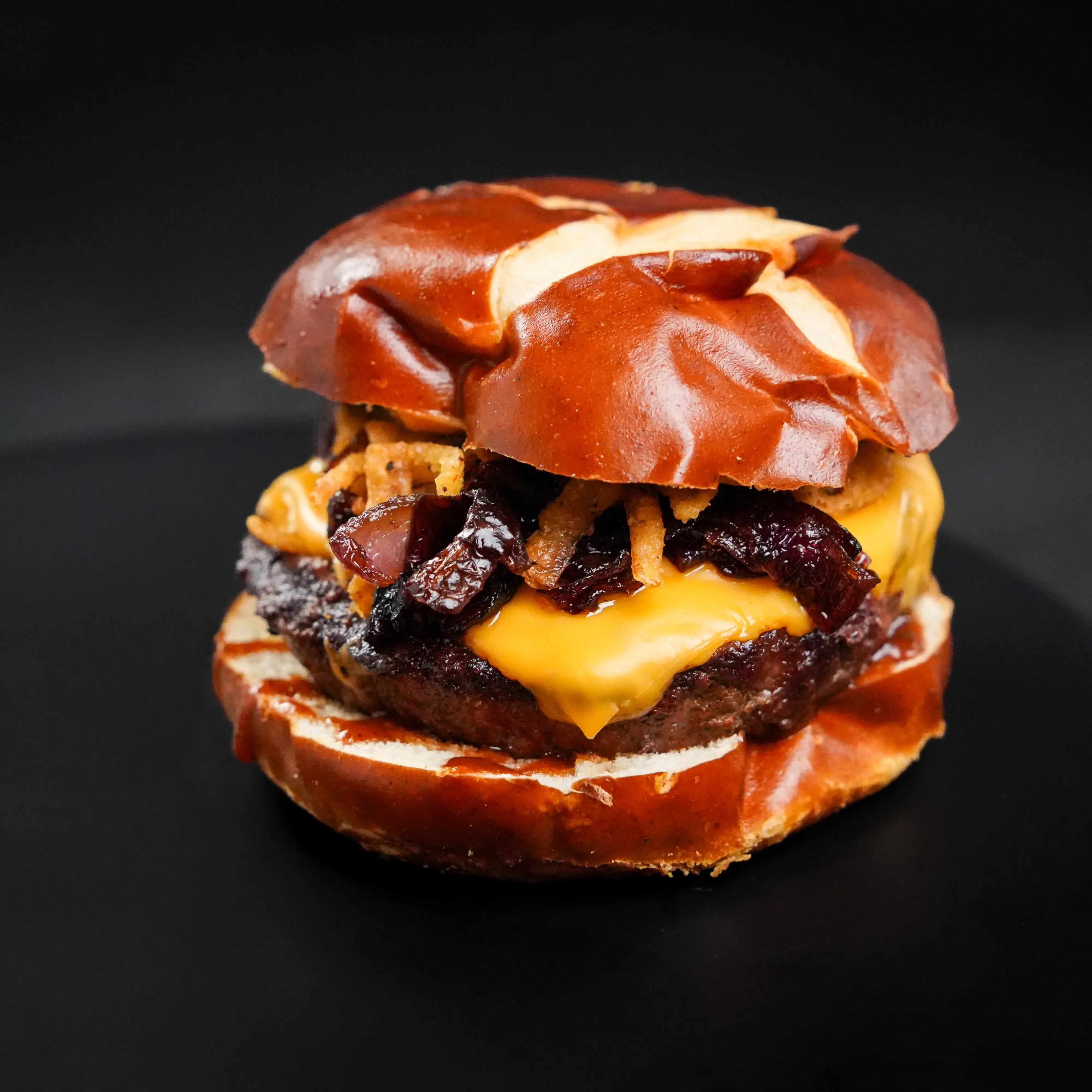 cooked burger on cutting board