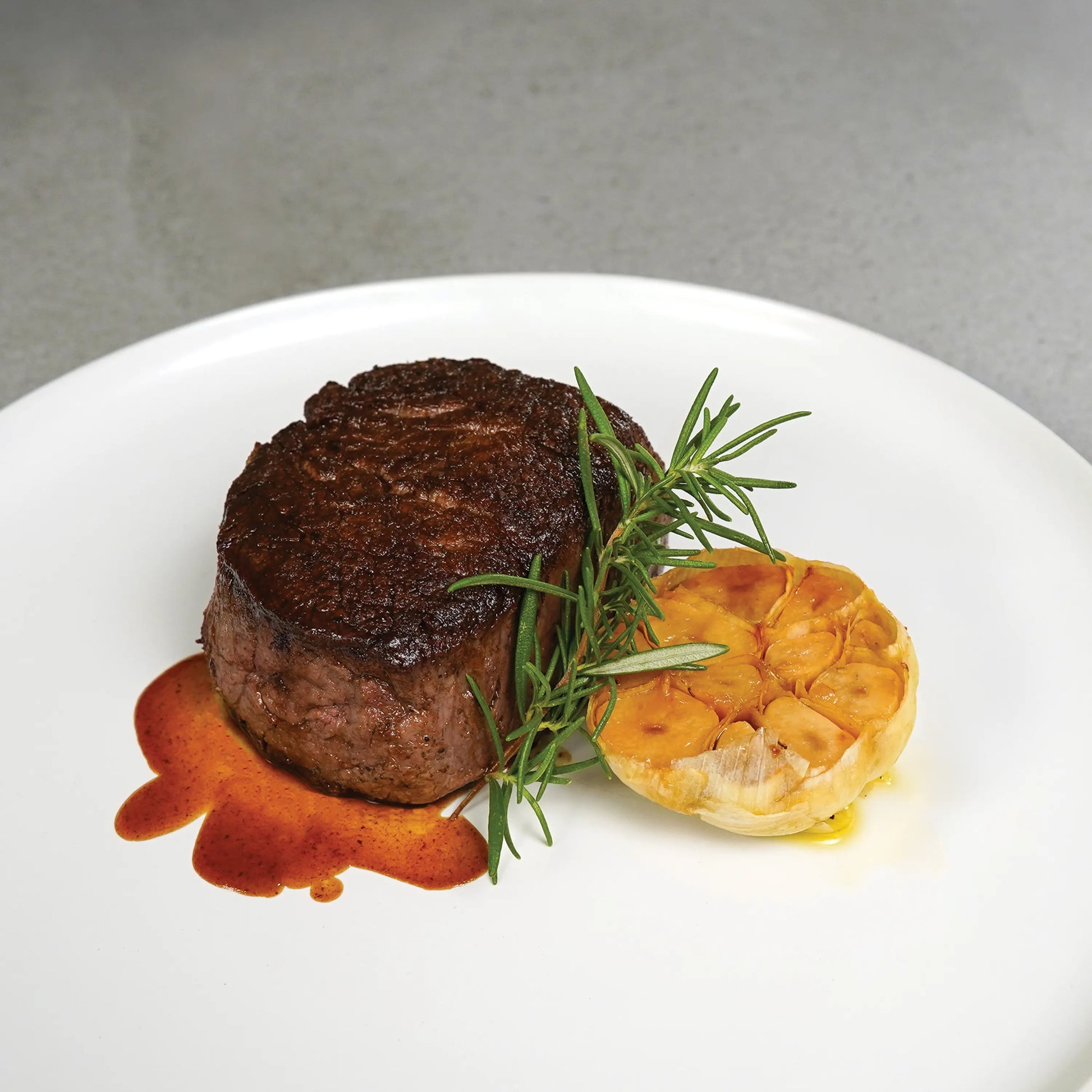 Close Up image of cooked filet on white plate