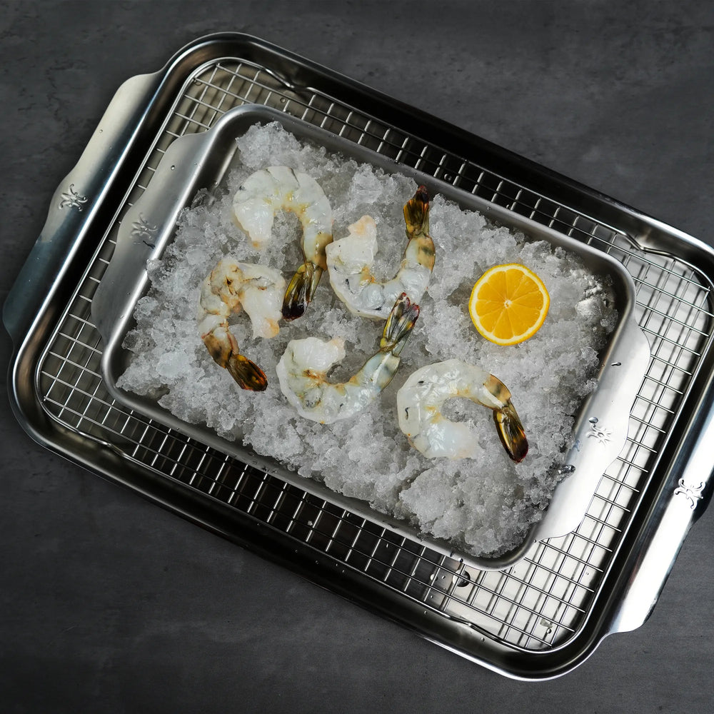 Raw Foley Black Tiger Shrimp on ice in a silver sheet pan with a lemon