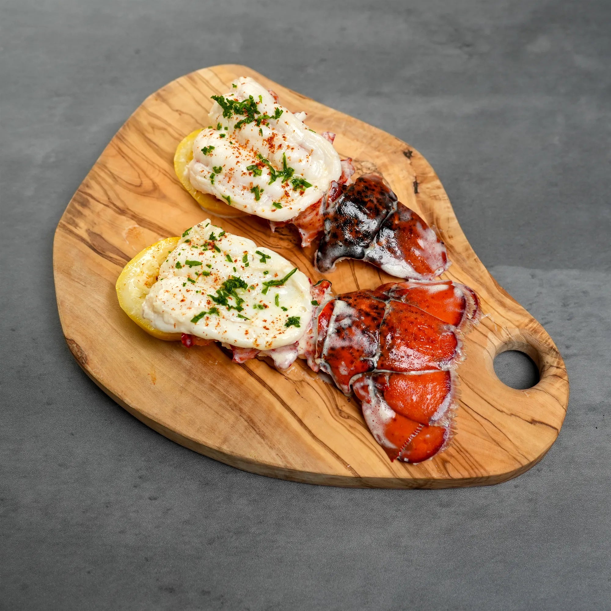 Foley Cold Water Whole Lobster Tails cooked on a wooden cutting board
