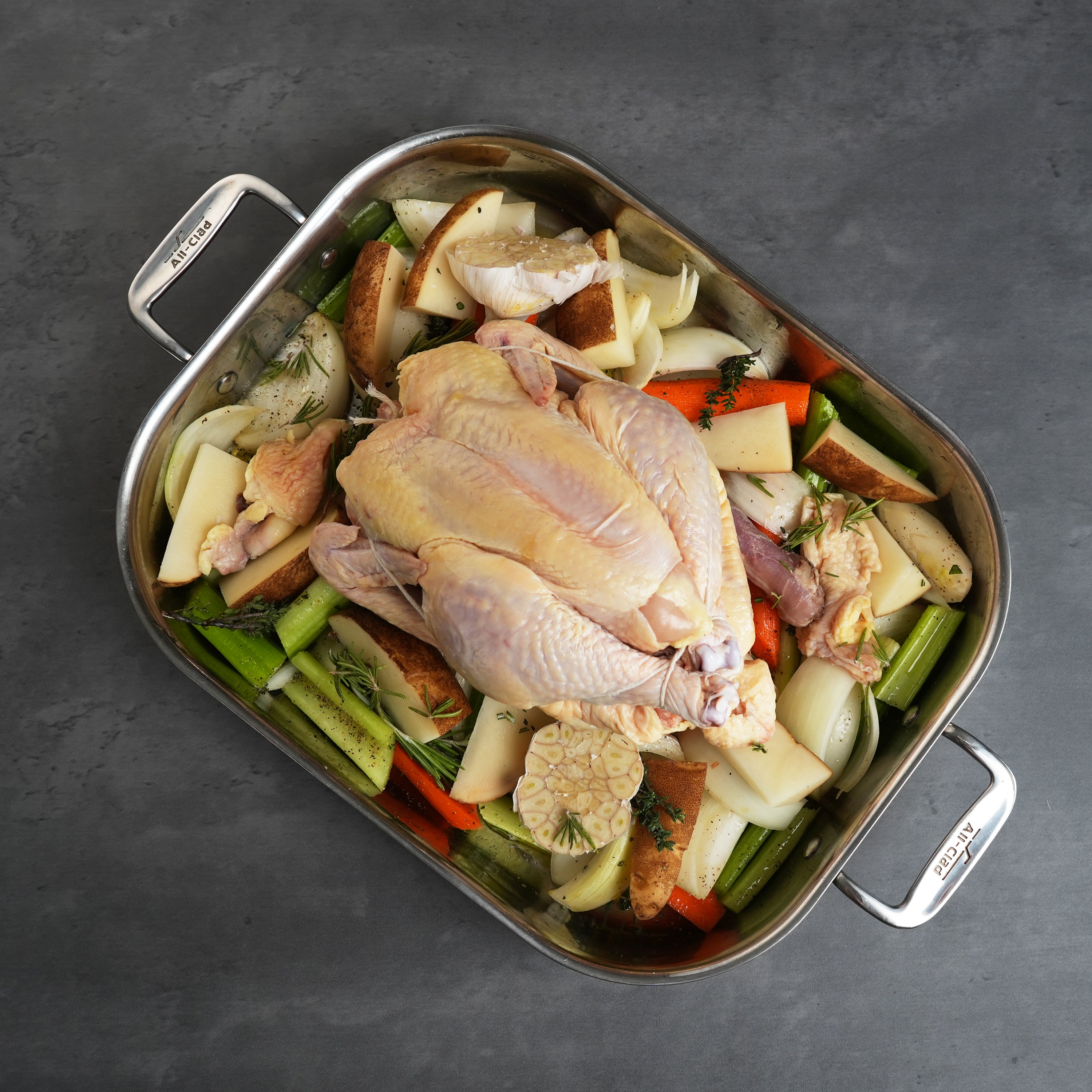 LaBelle Patrimoine whole chicken raw in prep tray on grey slate background