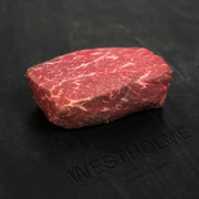 Australian Wagyu Center Cut Top Sirloin Steak on a branded cutting board; thick-cut, well-marbled, showcasing the rich texture and premium quality of Australian Wagyu beef.
